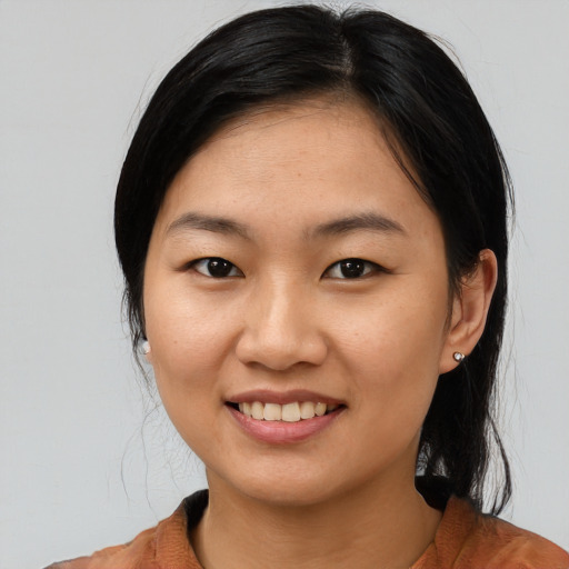 Joyful asian young-adult female with medium  black hair and brown eyes