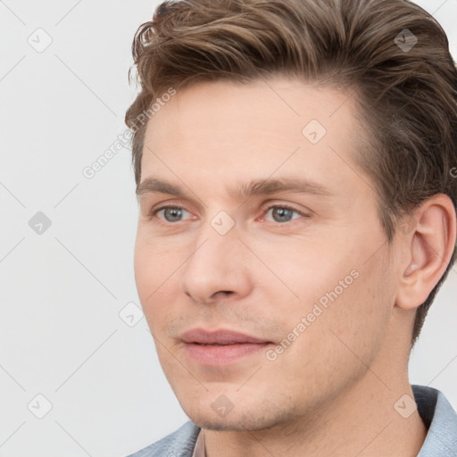 Joyful white young-adult male with short  brown hair and grey eyes