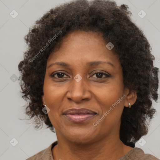 Joyful black adult female with short  brown hair and brown eyes