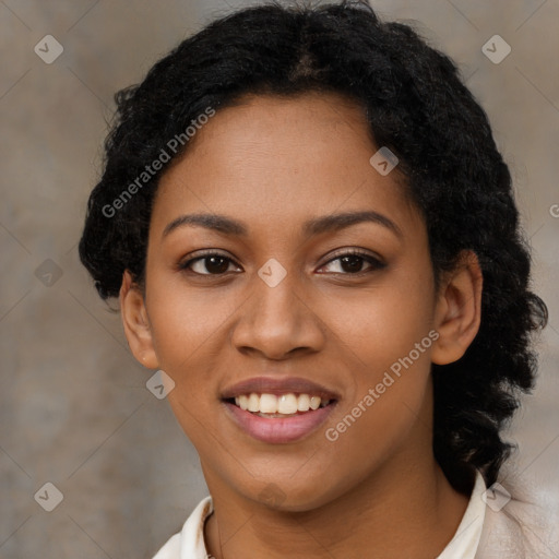 Joyful black young-adult female with long  black hair and brown eyes