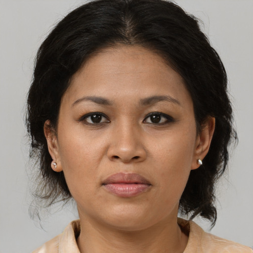 Joyful asian adult female with medium  brown hair and brown eyes