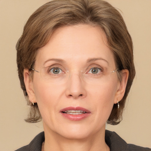 Joyful white adult female with medium  brown hair and grey eyes