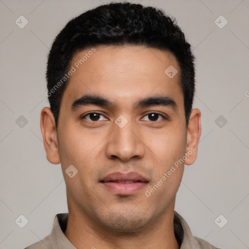 Joyful latino young-adult male with short  black hair and brown eyes
