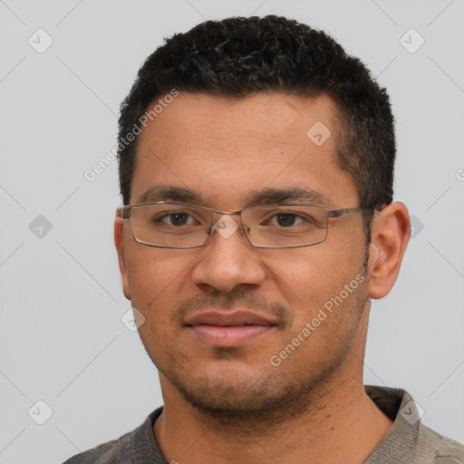 Joyful white young-adult male with short  black hair and brown eyes