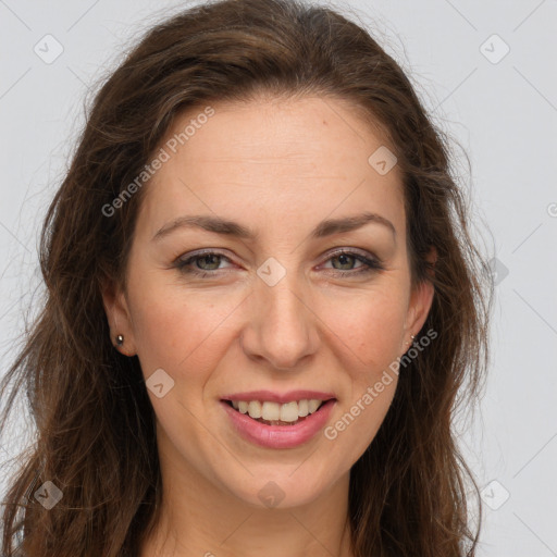 Joyful white adult female with long  brown hair and brown eyes