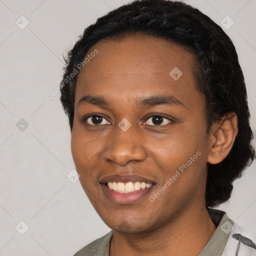 Joyful black young-adult female with short  black hair and brown eyes