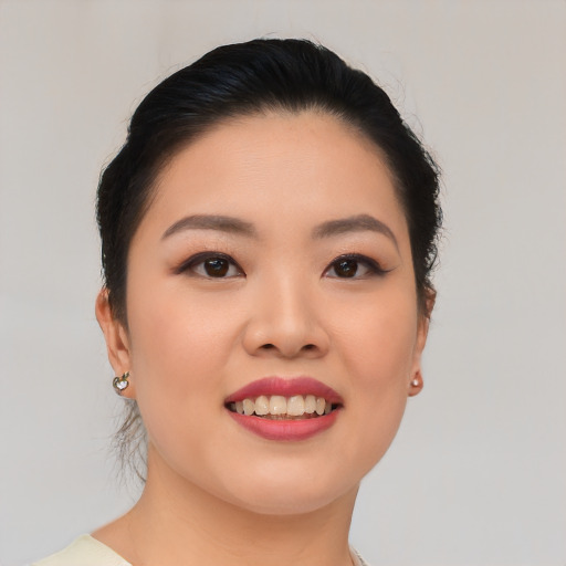 Joyful asian young-adult female with short  black hair and brown eyes