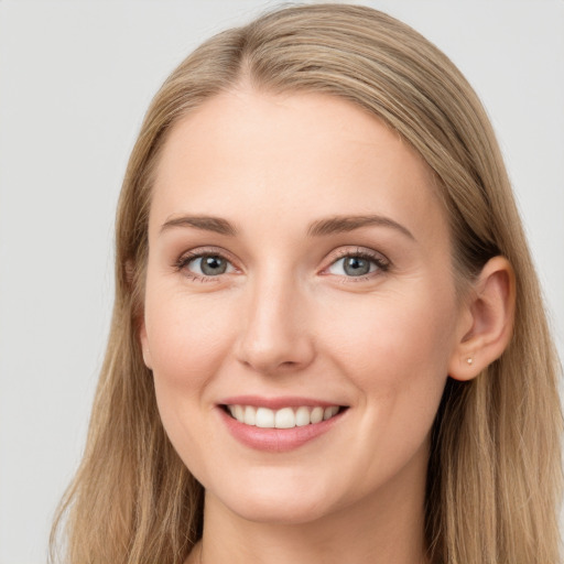 Joyful white young-adult female with long  brown hair and grey eyes