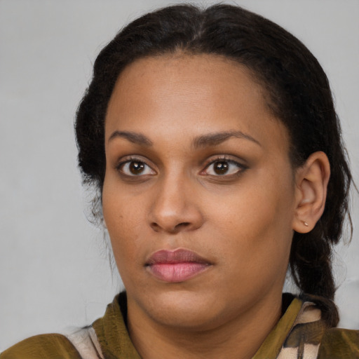 Joyful black young-adult female with long  brown hair and brown eyes