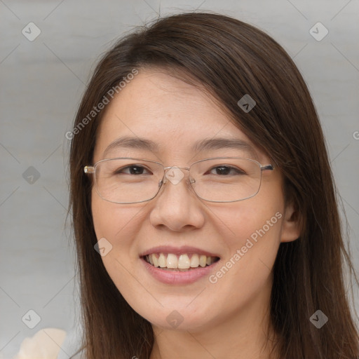 Joyful white adult female with long  brown hair and brown eyes