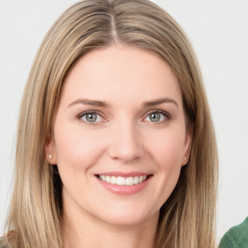 Joyful white young-adult female with long  brown hair and green eyes