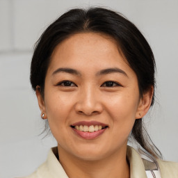 Joyful asian young-adult female with medium  brown hair and brown eyes