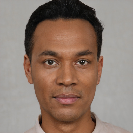 Neutral latino young-adult male with short  black hair and brown eyes