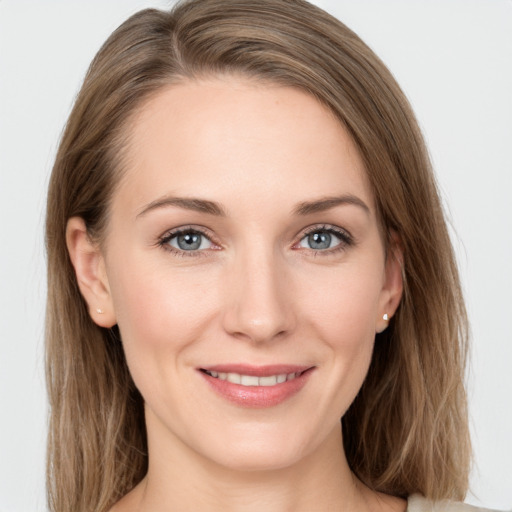 Joyful white young-adult female with long  brown hair and grey eyes