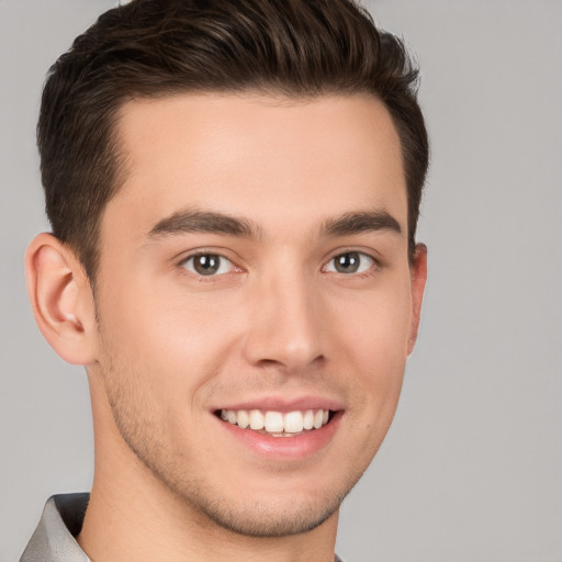 Joyful white young-adult male with short  brown hair and brown eyes