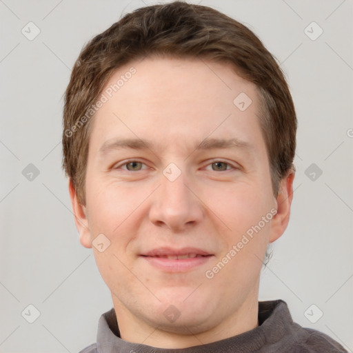 Joyful white adult male with short  brown hair and grey eyes