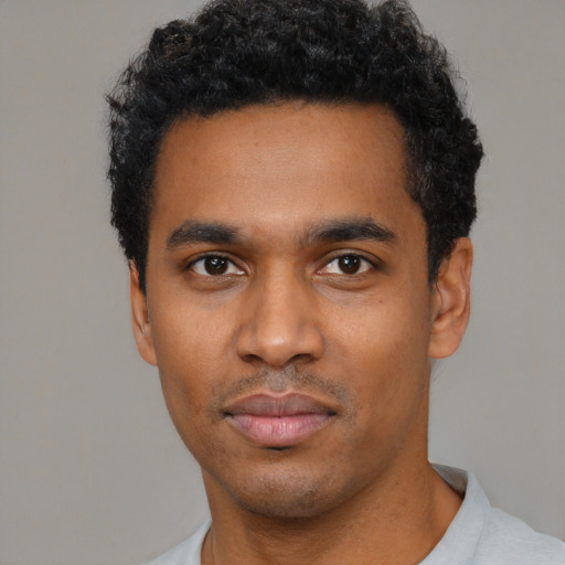 Neutral black young-adult male with short  black hair and brown eyes