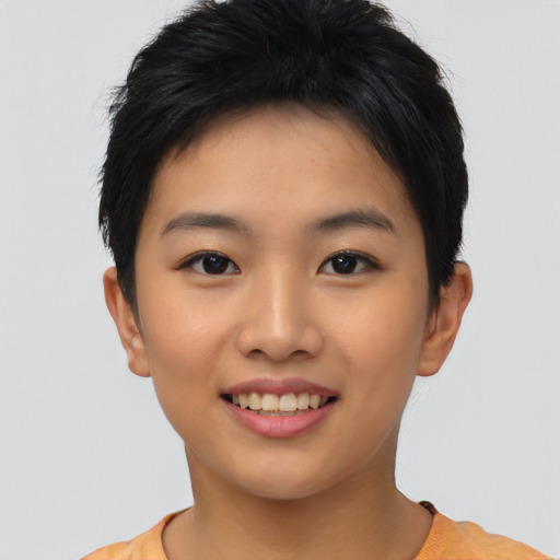 Joyful asian young-adult female with short  black hair and brown eyes