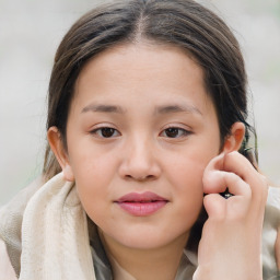 Joyful white child female with medium  brown hair and brown eyes