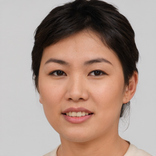 Joyful asian young-adult female with short  brown hair and brown eyes