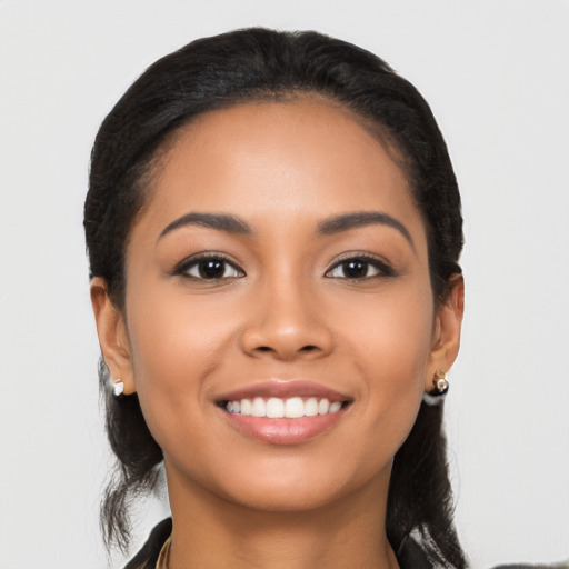 Joyful latino young-adult female with long  black hair and brown eyes