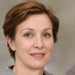 Joyful white adult female with medium  brown hair and grey eyes