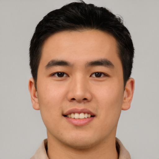 Joyful asian young-adult male with short  black hair and brown eyes