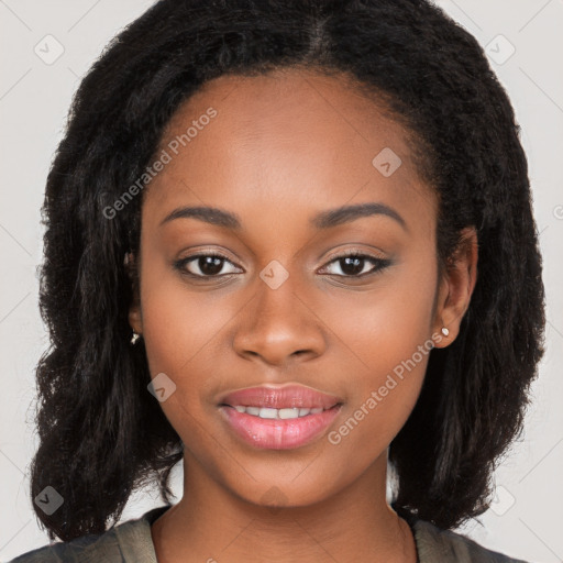 Joyful black young-adult female with long  brown hair and brown eyes