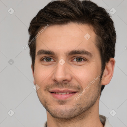 Joyful white young-adult male with short  brown hair and brown eyes