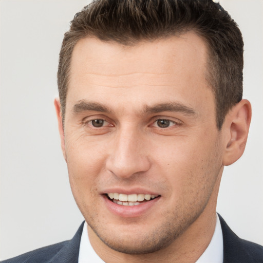 Joyful white young-adult male with short  brown hair and brown eyes