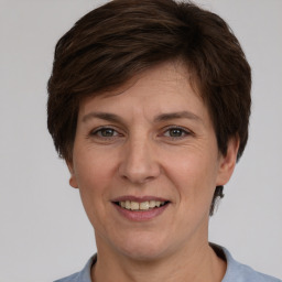 Joyful white adult female with short  brown hair and brown eyes