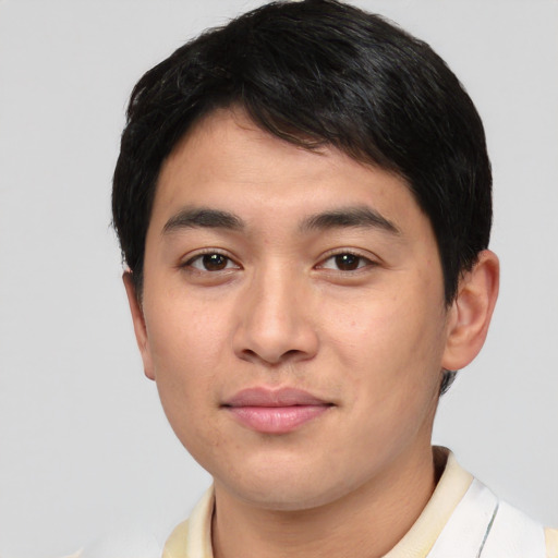 Joyful asian young-adult male with short  black hair and brown eyes
