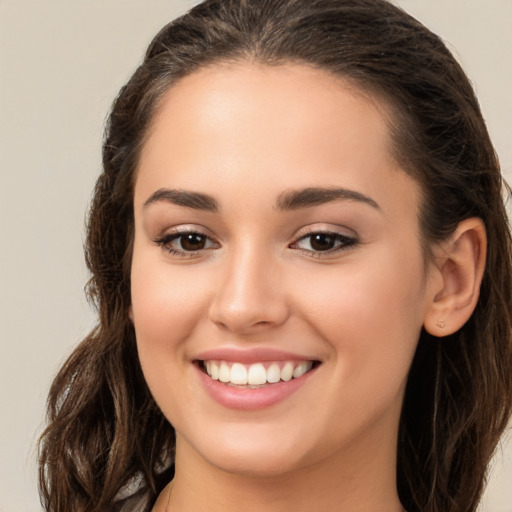 Joyful white young-adult female with long  brown hair and brown eyes