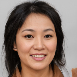 Joyful asian young-adult female with medium  brown hair and brown eyes