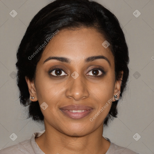 Joyful black young-adult female with medium  black hair and brown eyes