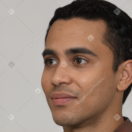 Joyful latino young-adult male with short  black hair and brown eyes