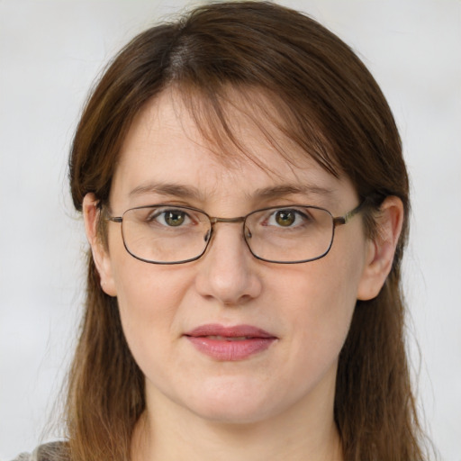 Joyful white adult female with medium  brown hair and blue eyes