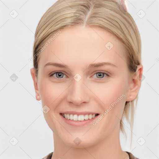 Joyful white young-adult female with medium  brown hair and blue eyes