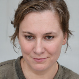 Joyful white young-adult female with medium  brown hair and blue eyes