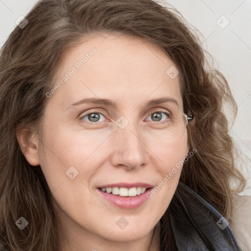 Joyful white young-adult female with long  brown hair and blue eyes