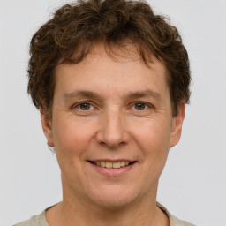 Joyful white adult male with short  brown hair and grey eyes