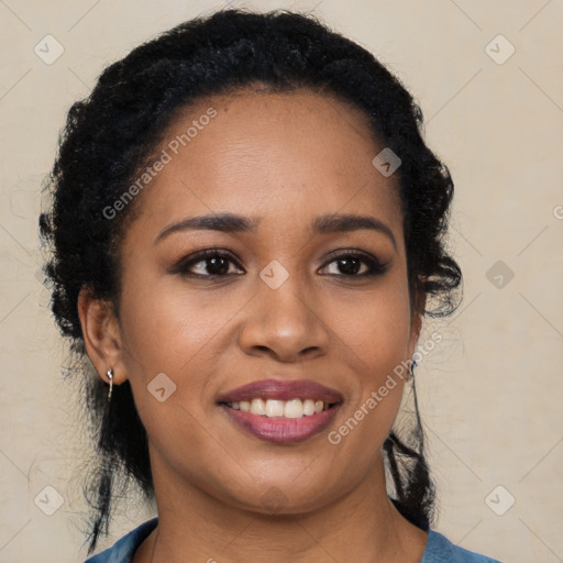 Joyful black young-adult female with long  black hair and brown eyes