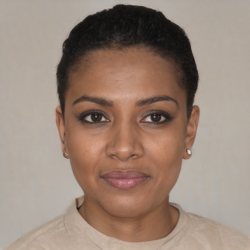 Joyful black young-adult female with short  black hair and brown eyes