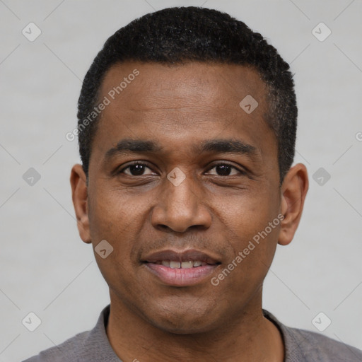 Joyful black young-adult male with short  black hair and brown eyes