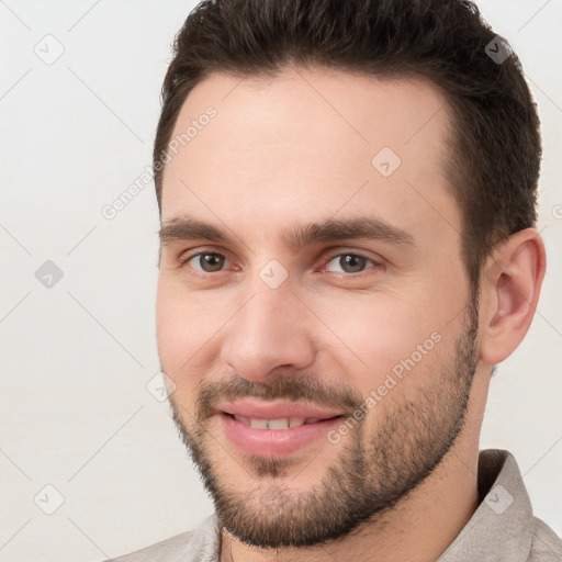 Joyful white young-adult male with short  brown hair and brown eyes