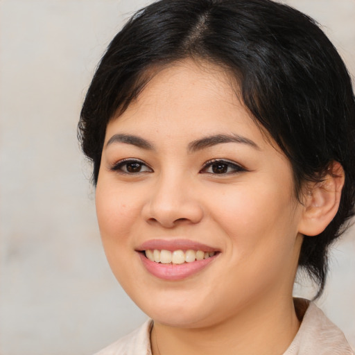 Joyful asian young-adult female with medium  brown hair and brown eyes
