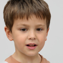 Joyful white child male with short  brown hair and brown eyes