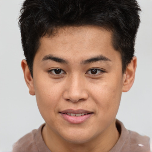 Joyful asian young-adult male with short  brown hair and brown eyes
