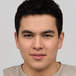 Joyful asian young-adult male with short  brown hair and brown eyes