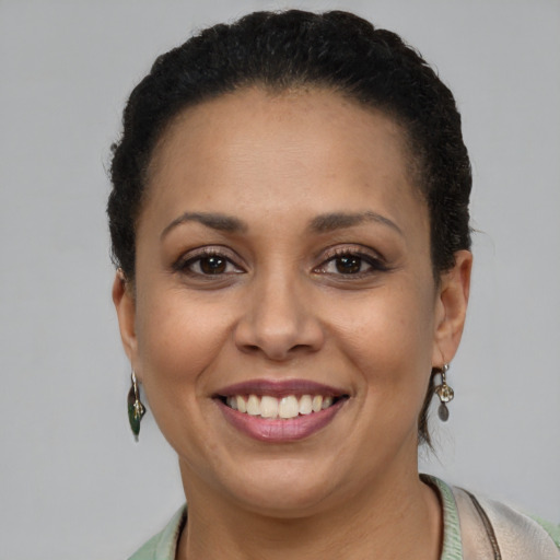 Joyful latino adult female with short  brown hair and brown eyes